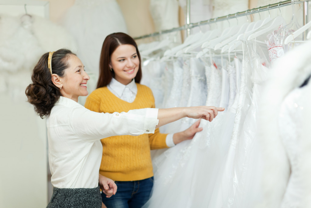 bride picking wedding gown