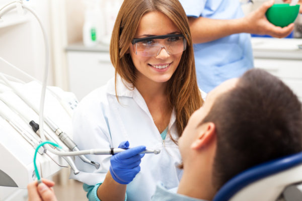 female dentist smiling to her patient
