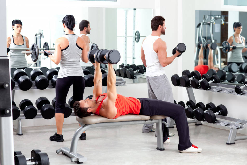 Athletes going through weight training in a gym.